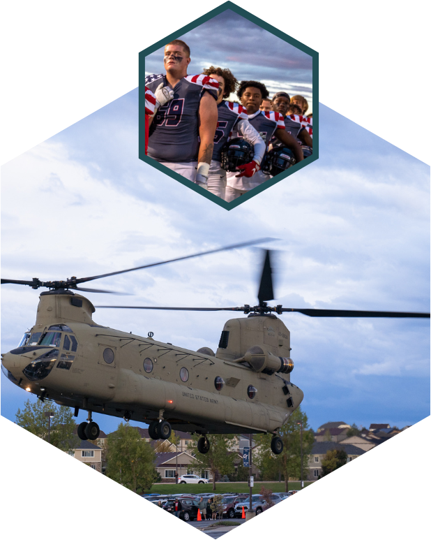 football players standing for national anthem and chinook helicopter